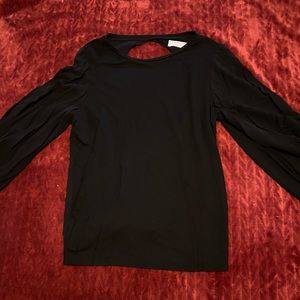 Like new backless blouse with tapered sleeves.